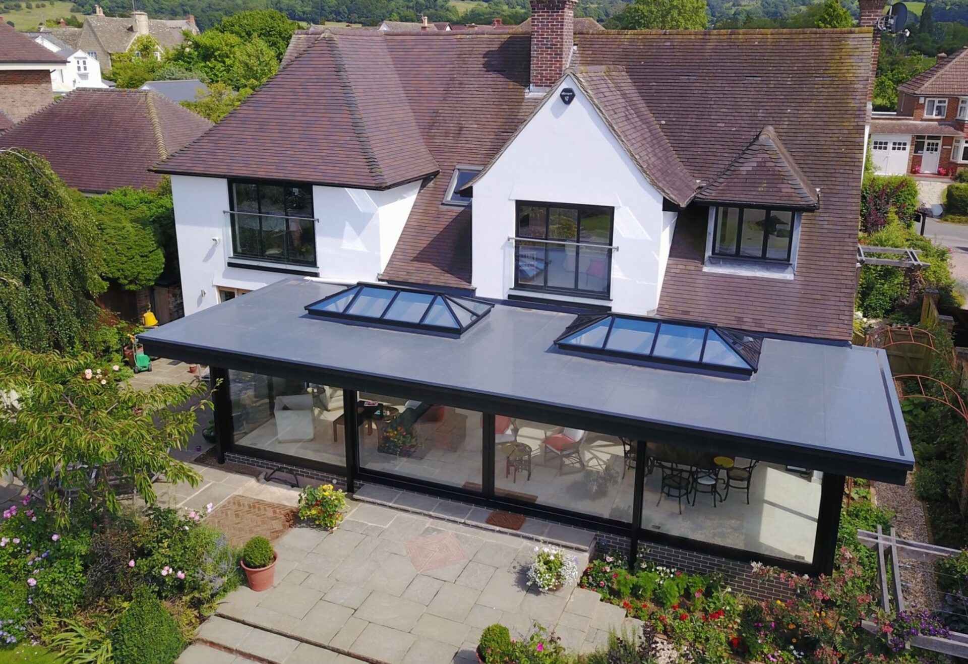 Home extension with window lanterns on flat roof